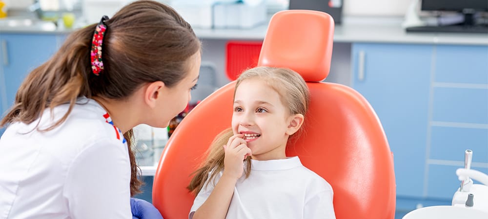 doctor check child teeth
