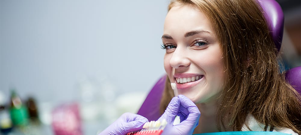 Dentist curing a woman patient in the dental office in a pleasant environment.