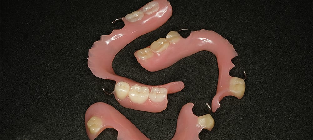 three temporary removable denture in black background