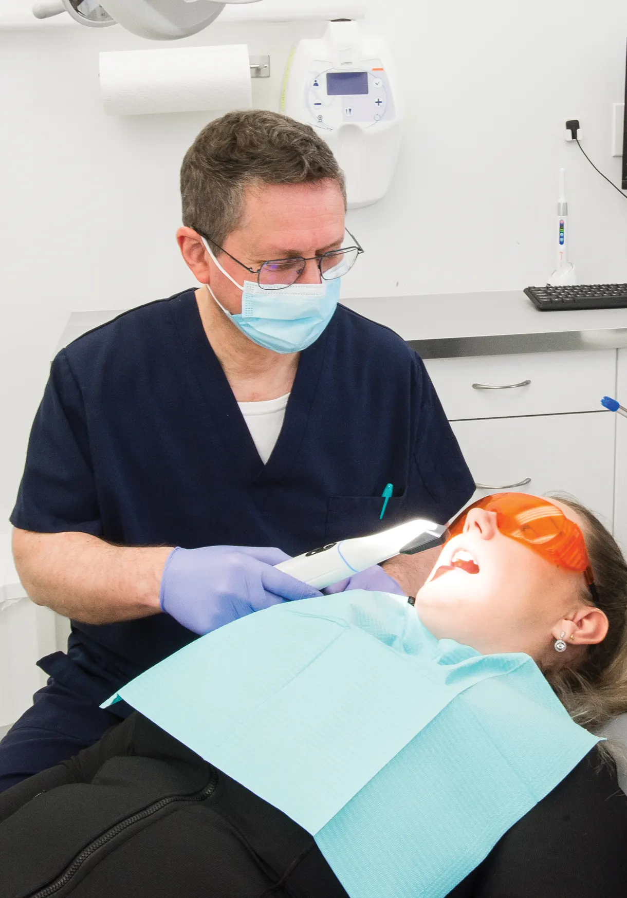 a dentist working on a patient for an emergency dental procedure